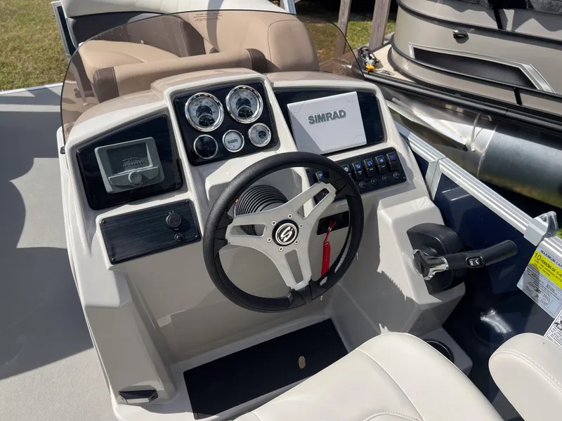 Slide: The Image of 2025 Sylvan Mirage 822 LZ boat dashboard with steering wheel and control panel. - 9