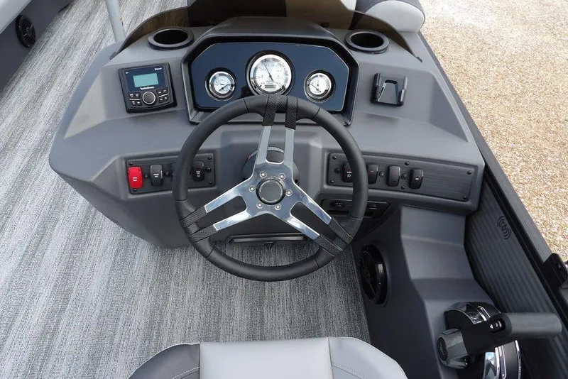 Slide: The Image of 2026 Bennington S Swingback 21 SSB boat dashboard with steering wheel and controls. - 21