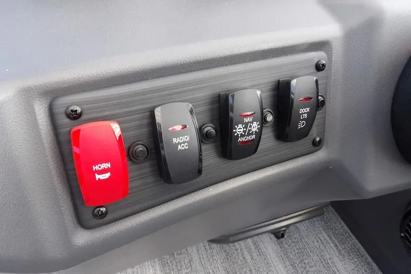 Slide: The Image of Control panel of 2026 Bennington S Swingback 21 SSB with horn, radio, navigation, and dock lights switches. - 24