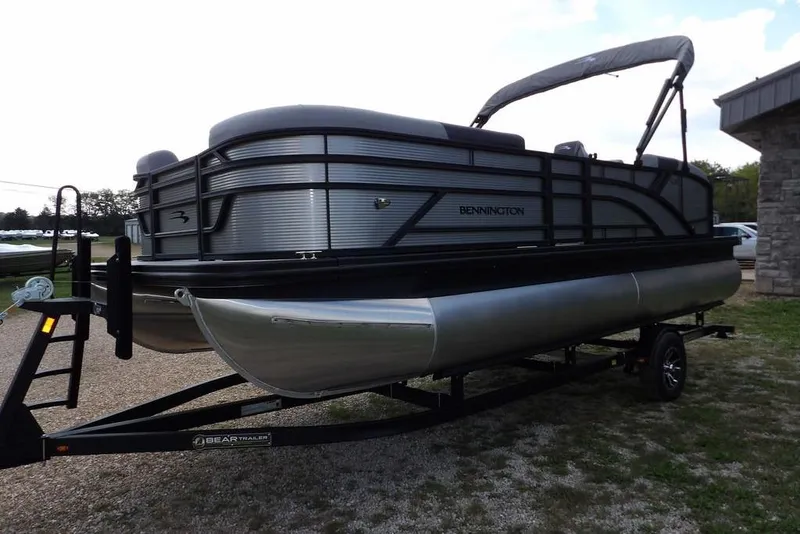 Slide: The Image of 2026 Bennington S Swingback 21 SSB pontoon boat on trailer, side view. - 3