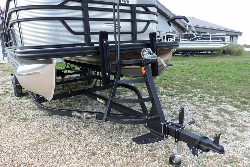Slide: The Image of 2026 Bennington S Swingback 21 SSB pontoon boat on a trailer, parked outdoors. - 40
