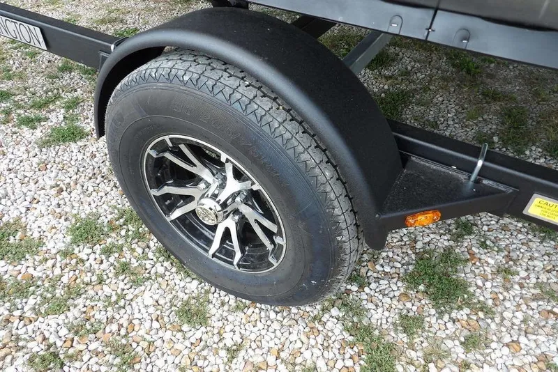 Slide: The Image of Trailer wheel of 2026 Bennington S Swingback 21 SSB on gravel surface. - 41