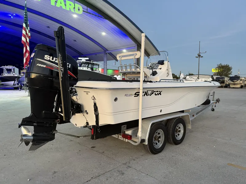 Slide: The Image of 2006 Sea Fox Bay Fisher 225 boat on trailer with Suzuki outboard motor. - 2