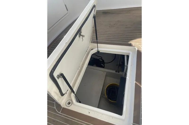 Slide: The Image of Open hatch on 2006 Nordic Tug 42 boat deck, revealing storage compartment. - 10