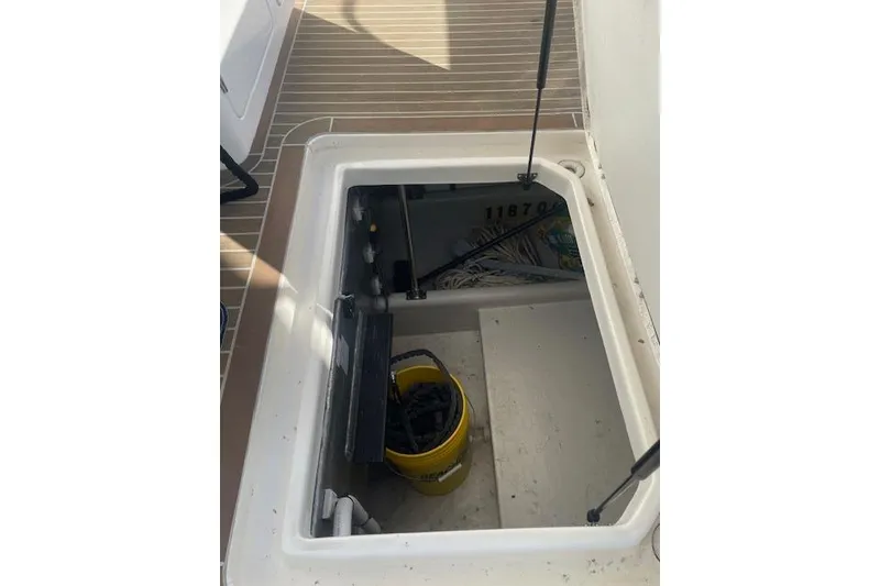 Slide: The Image of Open hatch on 2006 Nordic Tug 42 boat deck, revealing storage area with yellow bucket. - 11
