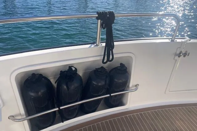 Slide: The Image of Nordic Tug 42 (2006) boat deck with fenders and rope, overlooking water. - 13