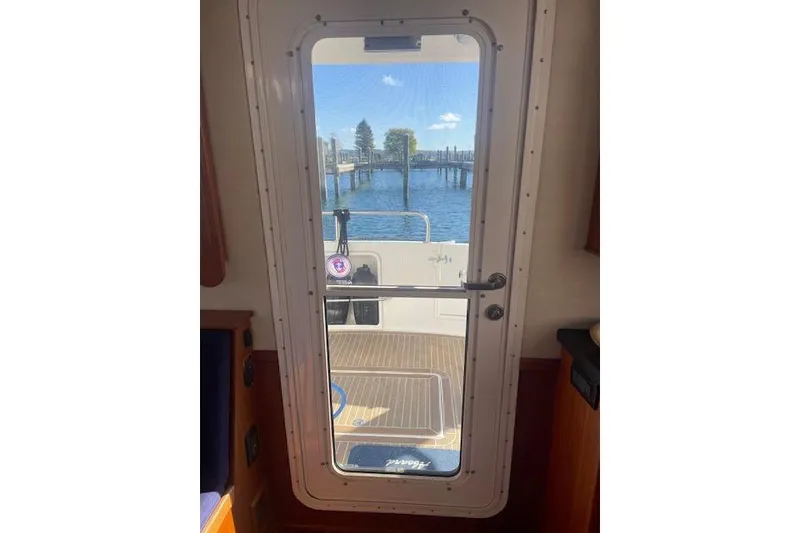 Slide: The Image of Interior view through door of 2006 Nordic Tug 42, overlooking water and dock. - 16