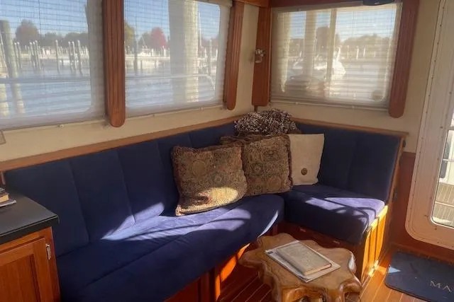 Slide: The Image of Cozy interior of 2006 Nordic Tug 42 with blue seating and decorative pillows. - 22