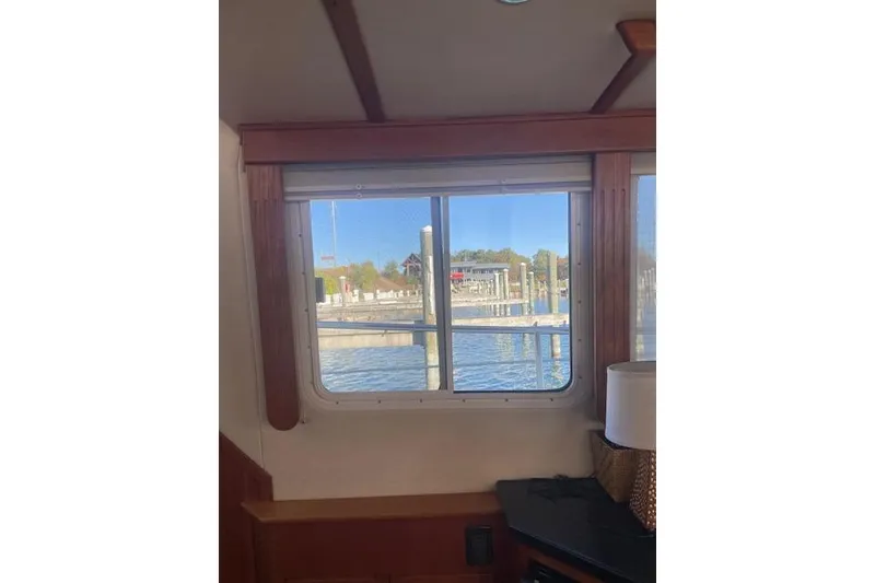 Slide: The Image of Interior view from a 2006 Nordic Tug 42, showcasing a window with a marina view. - 25