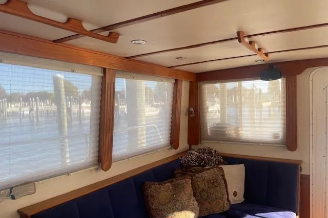 Slide: The Image of Interior of 2006 Nordic Tug 42 with cozy seating and large windows. - 26