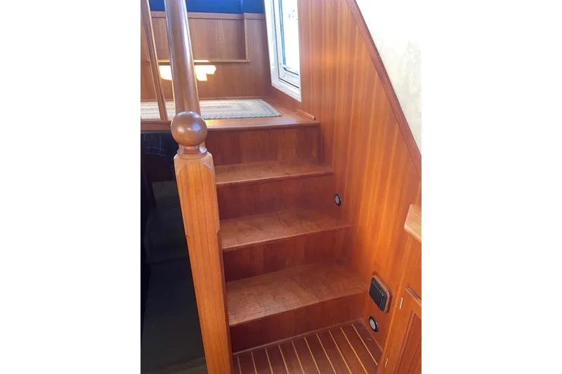 Slide: The Image of Wooden staircase inside 2006 Nordic Tug 42 boat, featuring polished handrail and steps. - 35