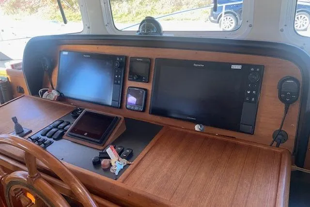 Slide: The Image of 2006 Nordic Tug 42 helm with navigation screens and controls. - 38