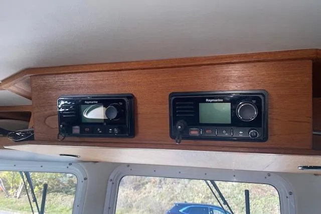 Slide: The Image of Wooden dashboard with Raymarine navigation equipment on a 2006 Nordic Tug 42 boat. - 39