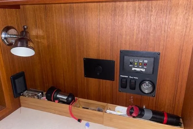 Slide: The Image of Control panel and storage area inside a 2006 Nordic Tug 42 boat. - 45