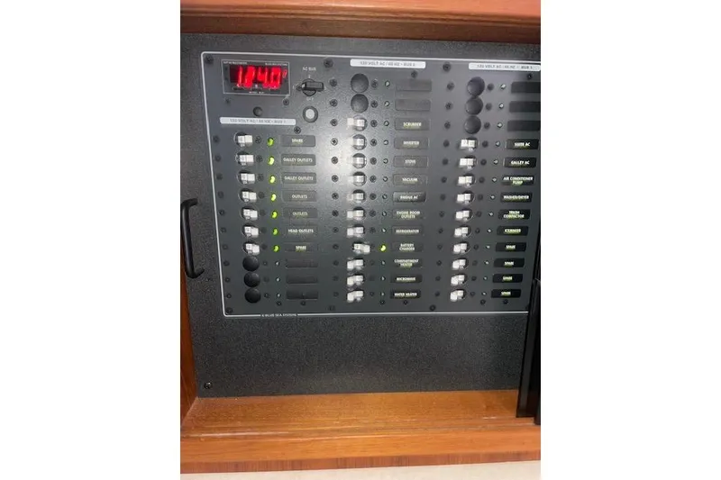 Slide: The Image of Electrical control panel on a 2006 Nordic Tug 42 boat, displaying various switches and indicators. - 47