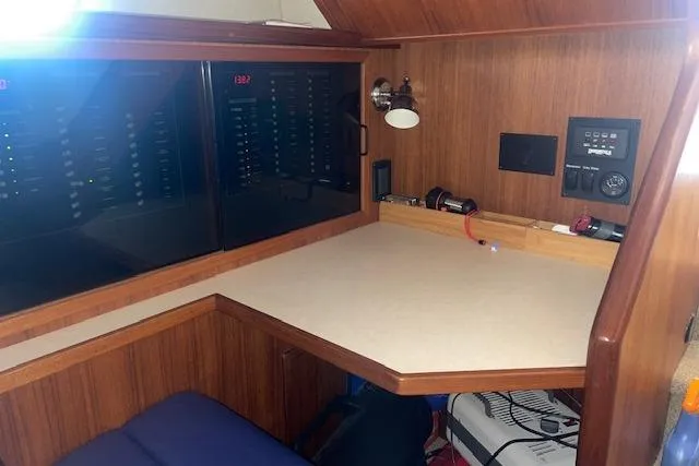 Slide: The Image of Navigation station in 2006 Nordic Tug 42 with control panels and wooden finish. - 49