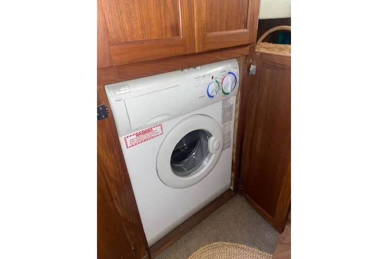 Slide: The Image of Washing machine inside a 2006 Nordic Tug 42 wooden cabinet. - 50