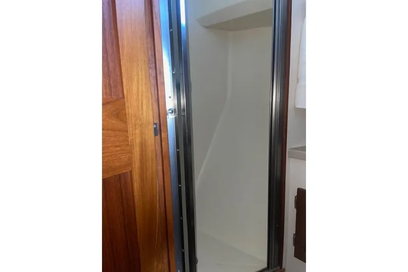 Slide: The Image of Wooden door and shower area inside 2006 Nordic Tug 42 boat. - 55