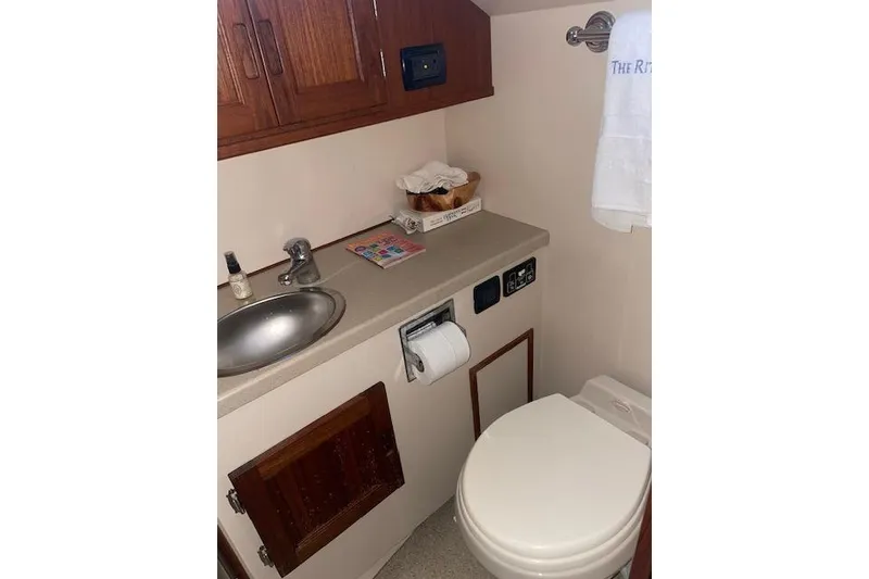 Slide: The Image of Small bathroom in 2006 Nordic Tug 42 with sink, toilet, and wooden cabinetry. - 57