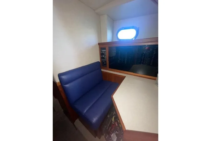 Slide: The Image of Interior of 2006 Nordic Tug 42 with blue seating and control panel. - 59