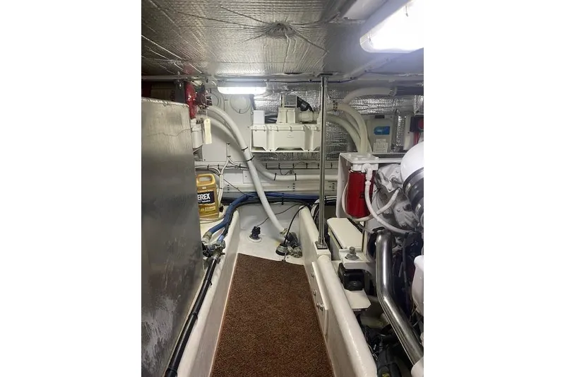 Slide: The Image of Engine room of a 2006 Nordic Tug 42, featuring mechanical components and storage. - 60