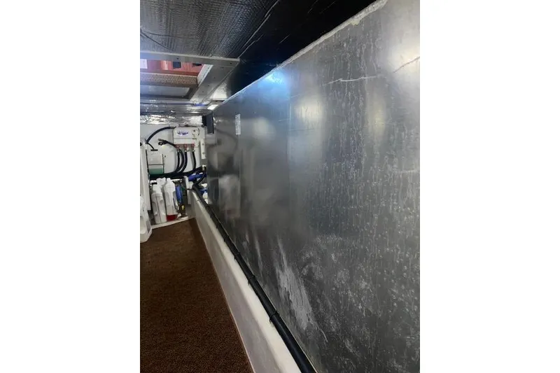 Slide: The Image of Engine room of a 2006 Nordic Tug 42, showcasing equipment and metallic surfaces. - 66