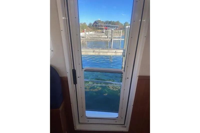 Slide: The Image of View from inside a 2006 Nordic Tug 42, looking out at a marina. - 75
