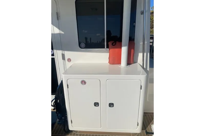 Slide: The Image of Nordic Tug 42 (2006) boat deck with storage cabinet and life jackets. - 9