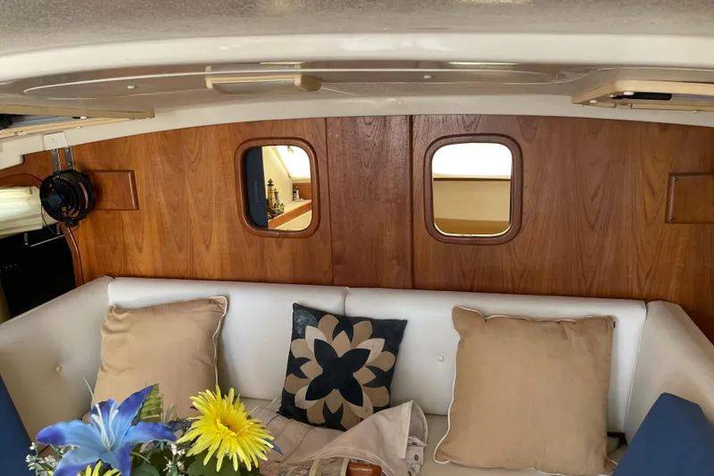 Slide: The Image of Interior of 2009 PCI 105 MC boat with cozy seating and decorative pillows. - 14