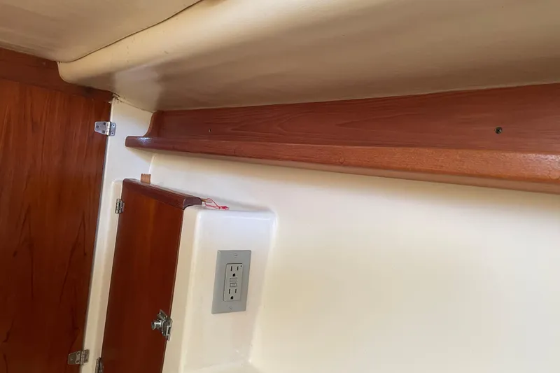 Slide: The Image of Interior of PCI 105 MC 2009 boat with wooden cabinetry and electrical outlet. - 23