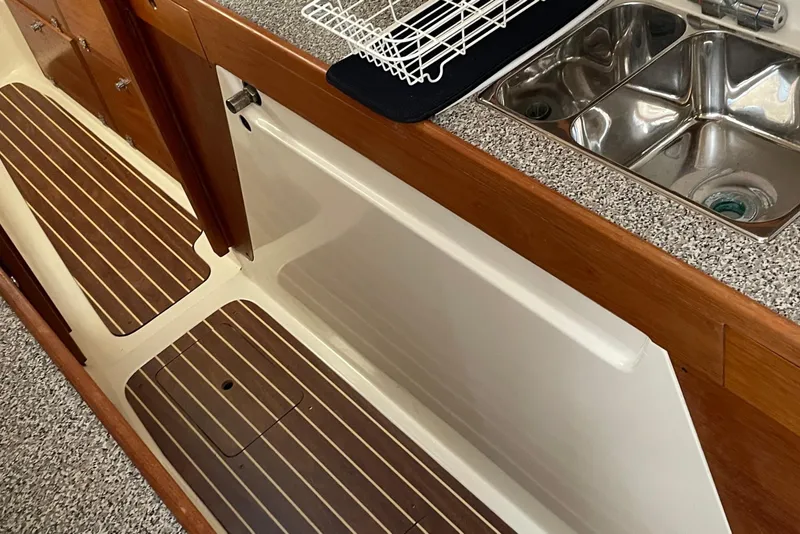 Slide: The Image of 2009 PCI 105 MC boat interior with wooden flooring and stainless steel sink. - 25