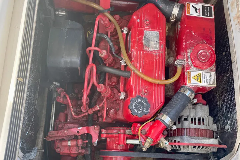 Slide: The Image of Red PCI 105 MC engine from 2009, featuring hoses and warning labels. - 27