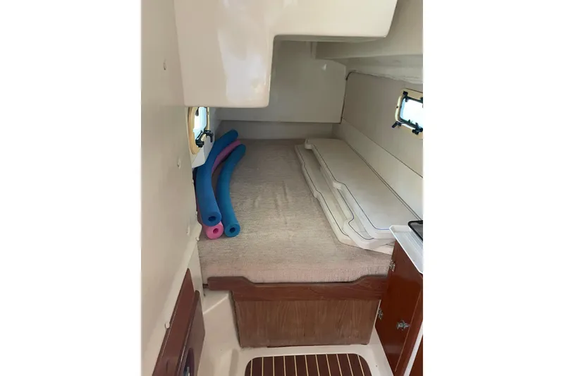 Slide: The Image of Cozy cabin interior of 2009 PCI 105 MC boat with cushions and pool noodles. - 29