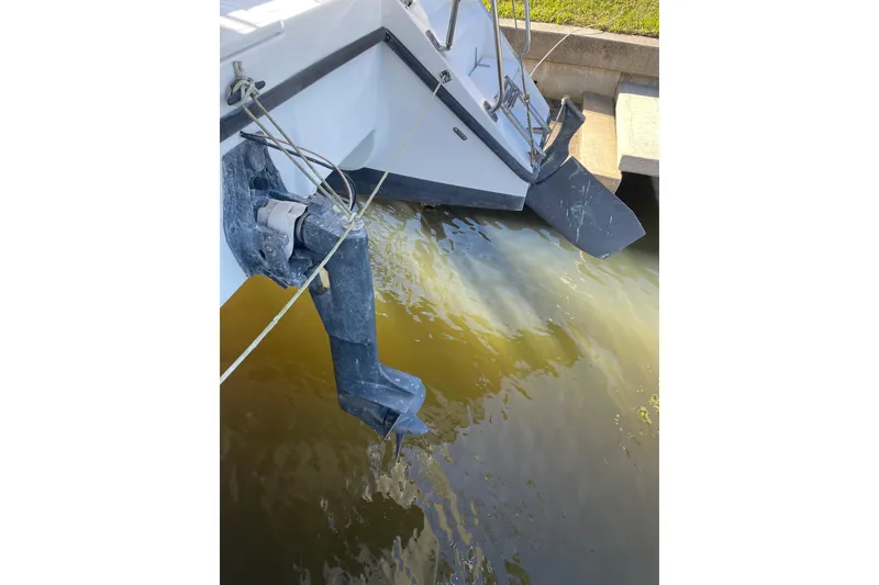 Slide: The Image of Boat stern with motor and rudder, PCI 105 MC, 2009 model, docked in water. - 3