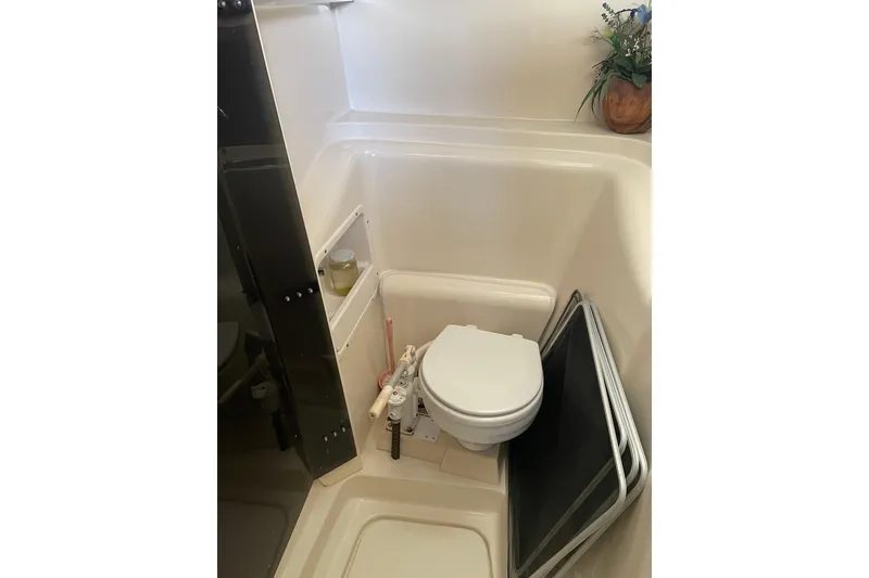 Slide: The Image of Compact bathroom in a 2009 PCI 105 MC boat with toilet and decor. - 30