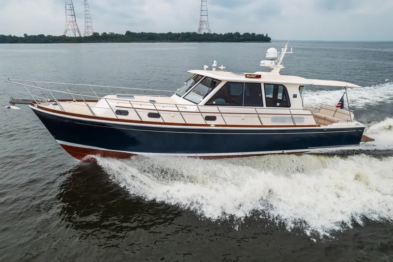 The Image of 2011 Grand Banks 46 Eastbay SX cruising on open water under a clear sky. - 0
