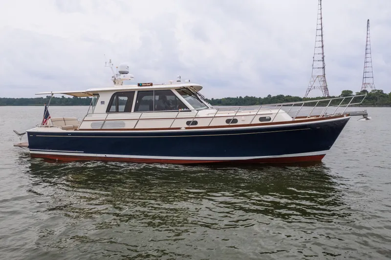 Slide: The Image of 2011 Grand Banks 46 Eastbay SX yacht on calm water, side view. - 19