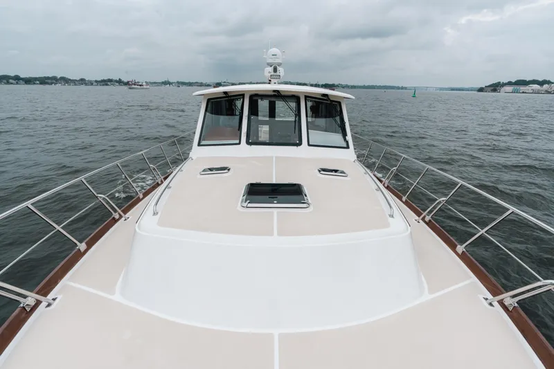 Slide: The Image of 2011 Grand Banks 46 Eastbay SX yacht on open water, cloudy sky. - 21