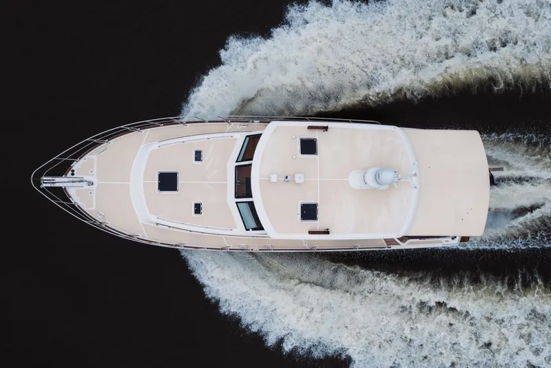 Slide: The Image of Overhead view of 2011 Grand Banks 46 Eastbay SX yacht cruising on water. - 23