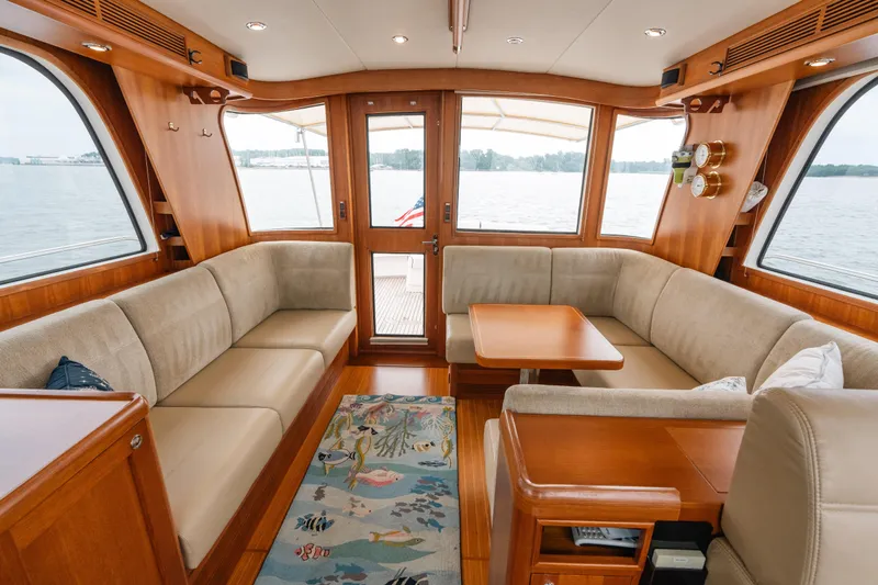 Slide: The Image of Luxurious 2011 Grand Banks 46 Eastbay SX yacht interior with plush seating and elegant wood finishes. - 4