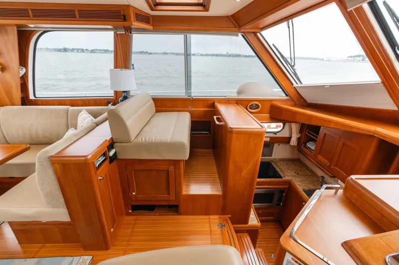 Slide: The Image of Luxurious 2011 Grand Banks 46 Eastbay SX yacht interior with elegant wood finish and waterfront view. - 9
