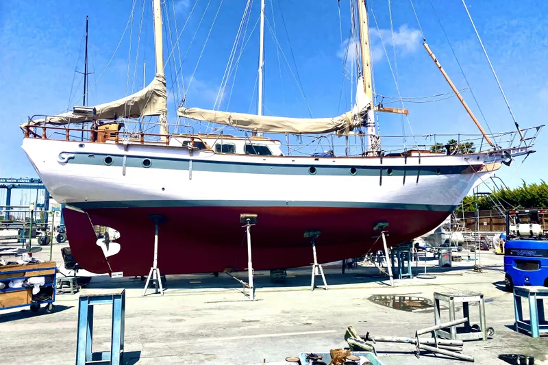 Slide: The Image of Vintage 1979 Formosa 51 sailboat on dry dock, showcasing classic design and craftsmanship. - 1
