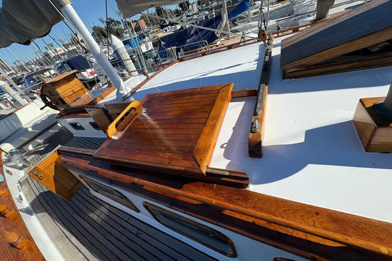 Slide: The Image of 1979 Formosa 51 sailboat deck with polished wood and nautical equipment. - 10