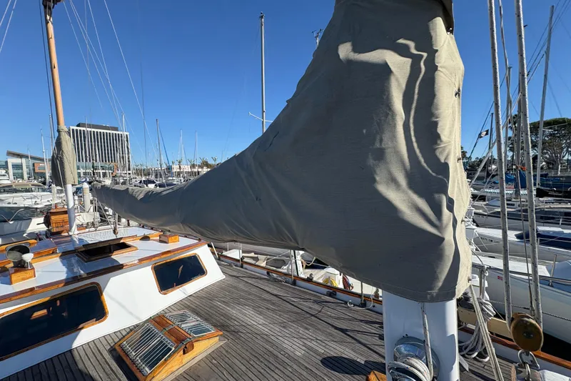 Slide: The Image of 1979 Formosa 51 sailboat deck with covered sail, docked in marina. - 11