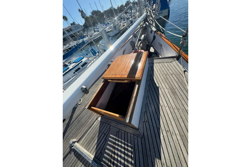 Slide: The Image of 1979 Formosa 51 sailboat deck with open wooden hatch, docked at marina. - 16