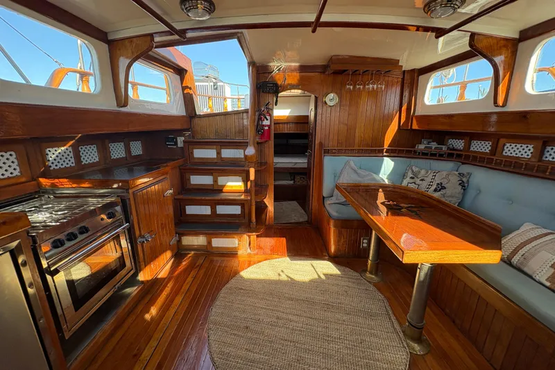 Slide: The Image of Interior of a 1979 Formosa 51 yacht with wooden finishes and cozy seating area. - 24