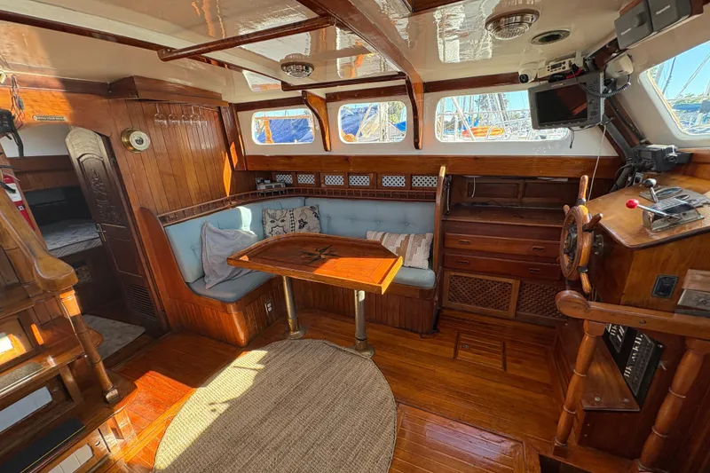 Slide: The Image of Interior of a 1979 Formosa 51 sailboat with wooden furnishings and nautical decor. - 25