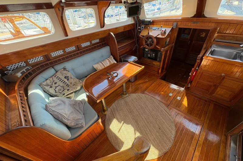 Slide: The Image of Interior of a 1979 Formosa 51 yacht with wooden furnishings and cozy seating area. - 26