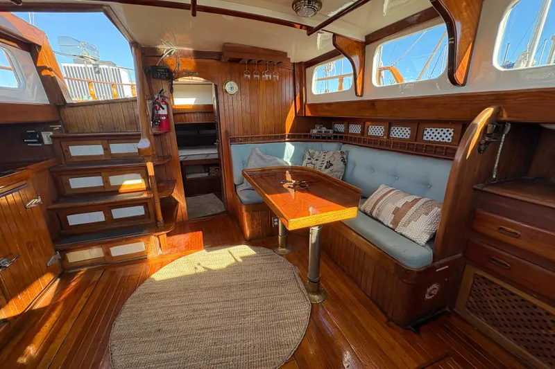 Slide: The Image of Interior of a 1979 Formosa 51 yacht with wooden decor and cozy seating area. - 27