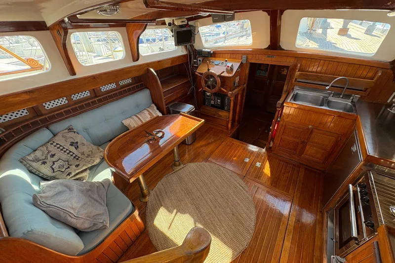 Slide: The Image of Interior of a 1979 Formosa 51 yacht with wooden finishes and cozy seating area. - 30